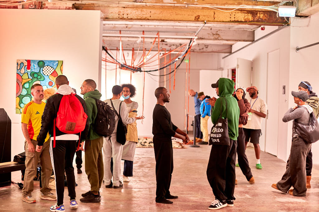 Visitors mingling in a bright gallery space
